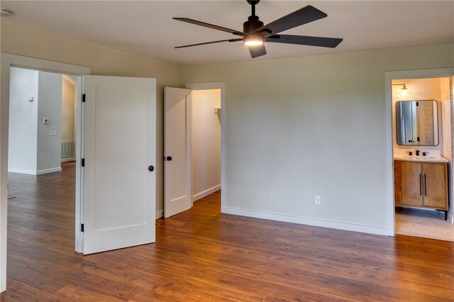 2593 Julienton Dr NE, Townsend, GA 31331 - unfurnished bedroom with wood finished floors, baseboards, and ensuite bath