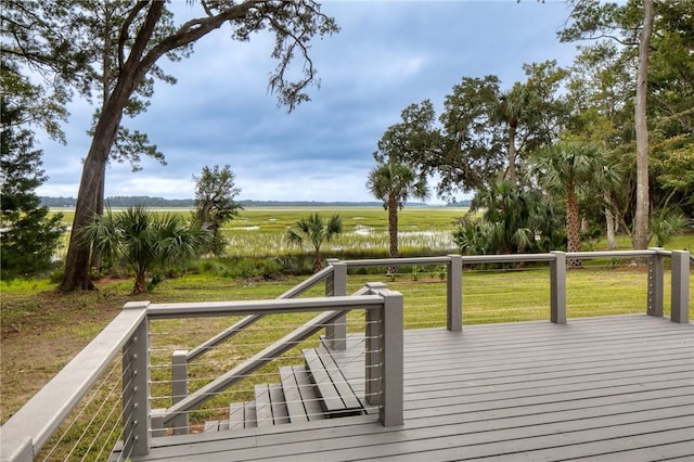 deck featuring a yard and a rural view