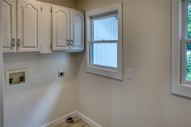 clothes washing area with hookup for a washing machine, cabinet space, a healthy amount of sunlight, electric dryer hookup, and baseboards