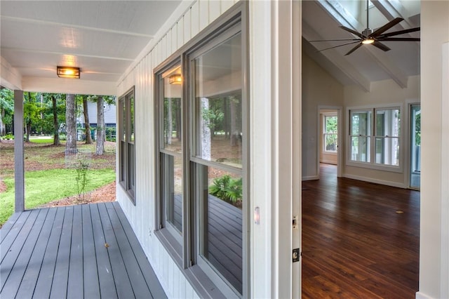 unfurnished sunroom featuring lofted ceiling with beams and ceiling fan