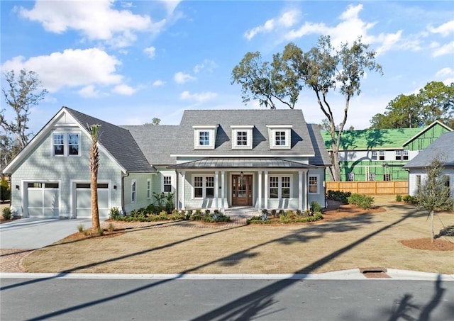 cape cod-style house with a garage and a porch