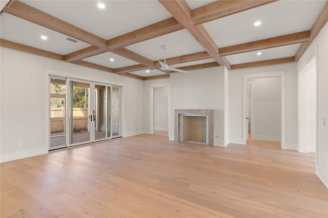 unfurnished living room featuring coffered ceiling, light hardwood / wood-style flooring, and beamed ceiling