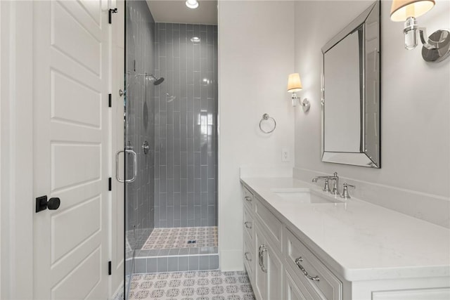 bathroom featuring walk in shower, vanity, and tile patterned flooring