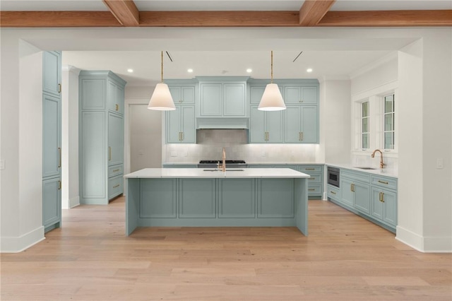 kitchen featuring pendant lighting, sink, and beam ceiling