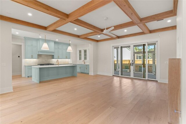 unfurnished living room with coffered ceiling, ceiling fan, beamed ceiling, and light wood-type flooring