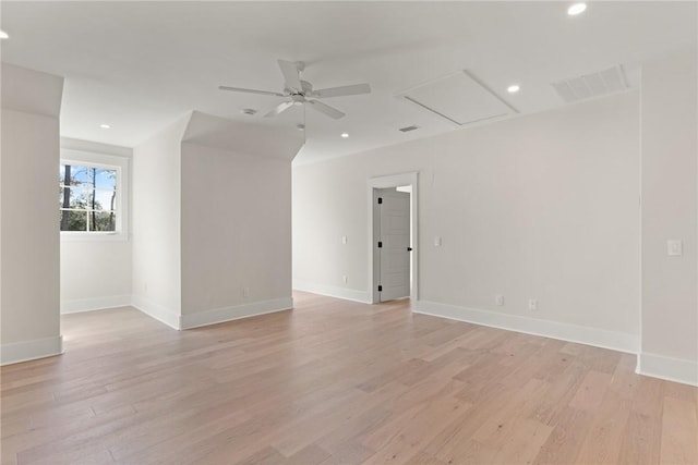 empty room with ceiling fan and light hardwood / wood-style flooring