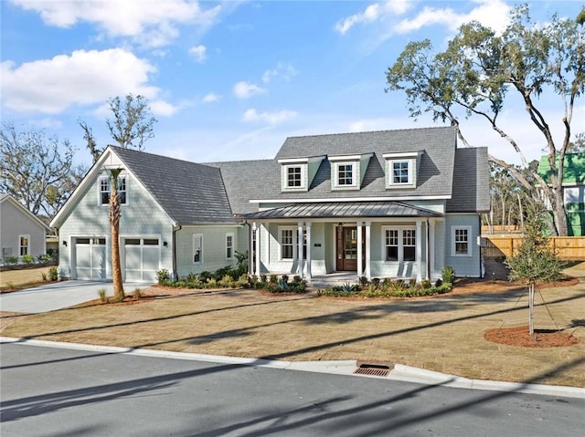 new england style home featuring a garage and a porch