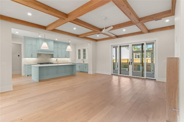 unfurnished living room featuring coffered ceiling, beam ceiling, light hardwood / wood-style flooring, and ceiling fan