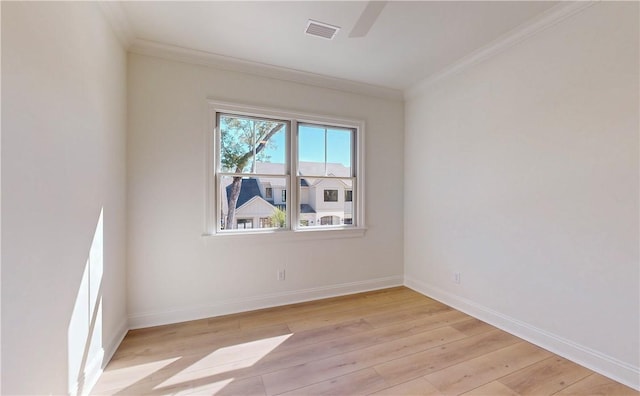 spare room with crown molding and light hardwood / wood-style flooring