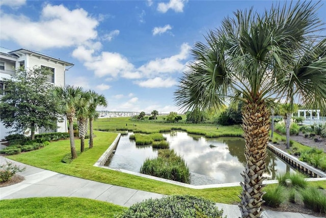 view of home's community featuring a water view and a yard