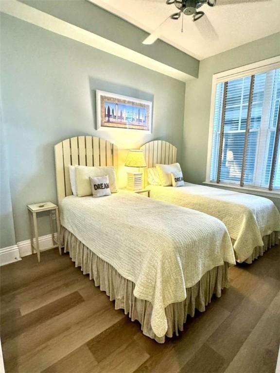 bedroom with wood-type flooring and ceiling fan