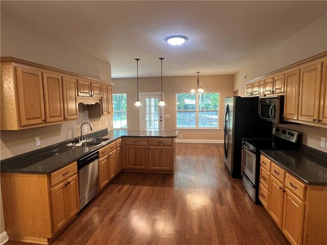 134 Hillery Trce, Brunswick, GA 31523 - kitchen with appliances with stainless steel finishes, a peninsula, dark wood finished floors, and dark countertops