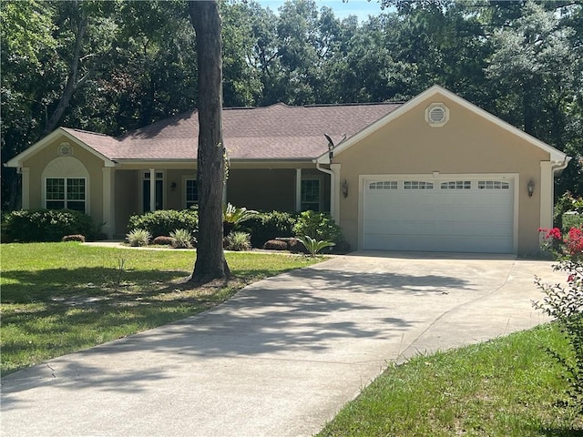 134 Hillery Trce, Brunswick, GA 31523 - ranch-style house with driveway, a garage, a front lawn, and stucco siding