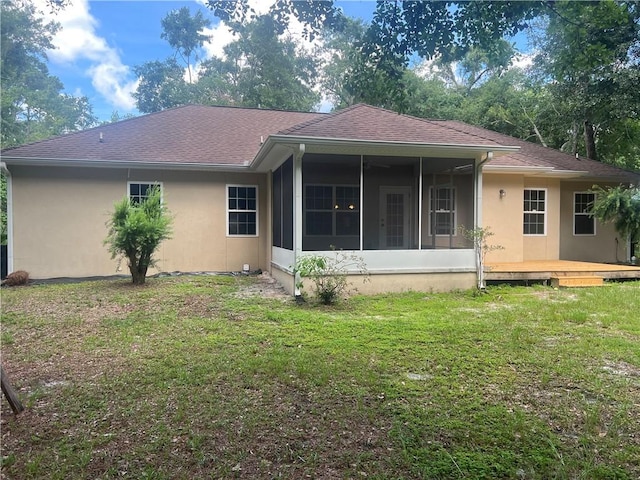 134 Hillery Trce, Brunswick, GA 31523 - back of property featuring a sunroom, a lawn, and stucco siding