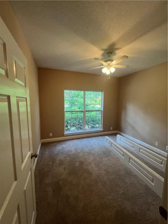134 Hillery Trce, Brunswick, GA 31523 - unfurnished room with dark colored carpet, a ceiling fan, and a textured ceiling