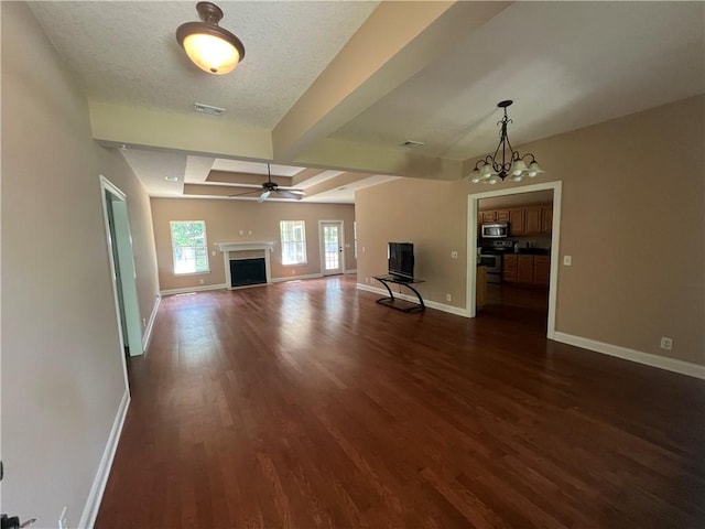 134 Hillery Trce, Brunswick, GA 31523 - unfurnished living room with dark wood-style floors, a fireplace, a chandelier, and a ceiling fan