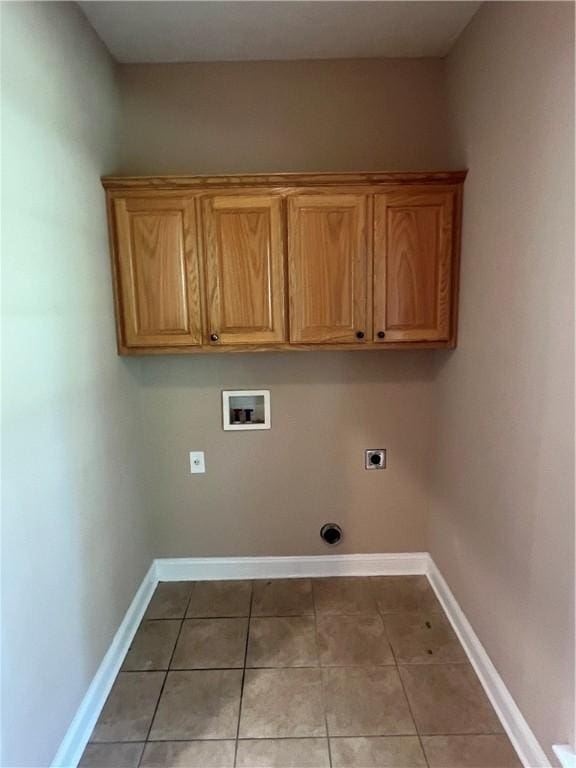 134 Hillery Trce, Brunswick, GA 31523 - washroom featuring hookup for a washing machine, electric dryer hookup, light tile patterned flooring, and cabinet space