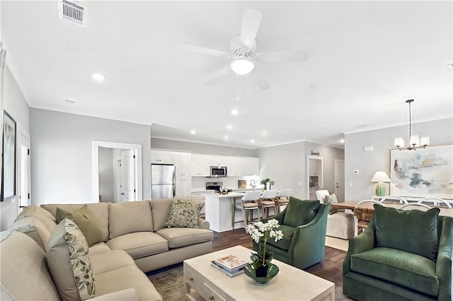 222 Bottlebrush Walk, Brunswick, GA 31525 - living room featuring dark wood finished floors, a ceiling fan, a chandelier, ornamental molding, and recessed lighting