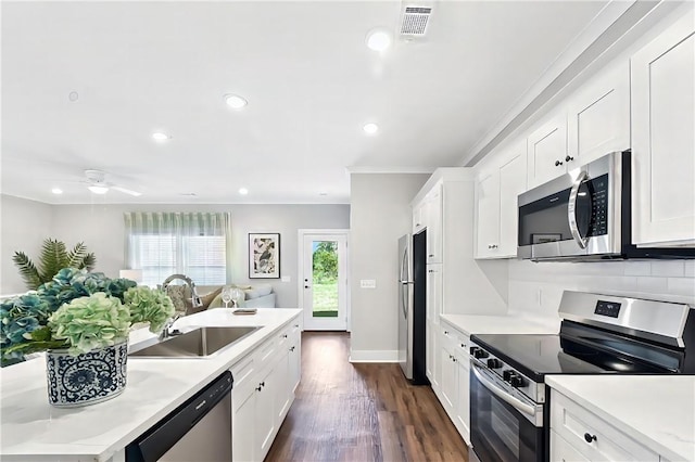 222 Bottlebrush Walk, Brunswick, GA 31525 - kitchen with appliances with stainless steel finishes, light countertops, open floor plan, white cabinetry, and dark wood-style floors