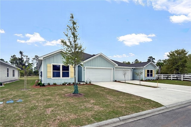 222 Bottlebrush Walk, Brunswick, GA 31525 - view of front of house with board and batten siding, an attached garage, and concrete driveway