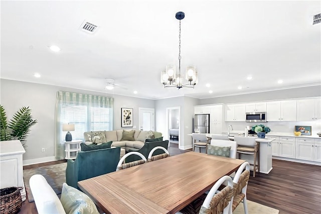 222 Bottlebrush Walk, Brunswick, GA 31525 - dining area featuring a chandelier, a ceiling fan, dark wood-style flooring, recessed lighting, and crown molding