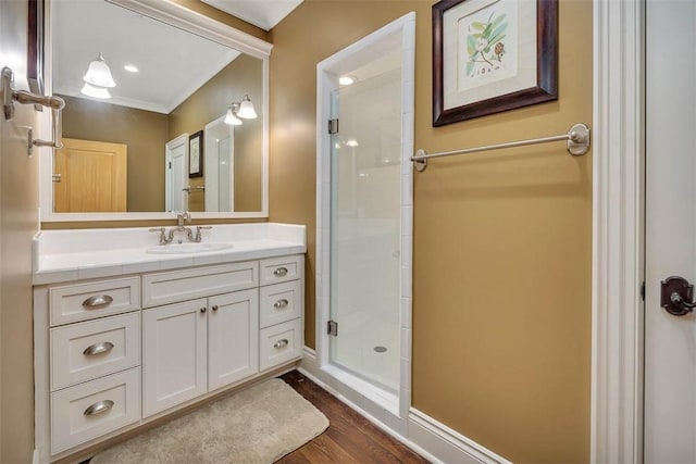 117 Hawkins Island Cir, Saint Simons Island, GA 31522 - bathroom with vanity, a stall shower, wood finished floors, baseboards, and ornamental molding