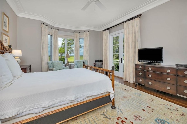 117 Hawkins Island Cir, Saint Simons Island, GA 31522 - bedroom featuring multiple windows, access to exterior, crown molding, wood finished floors, and french doors
