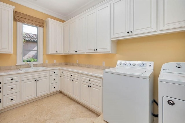117 Hawkins Island Cir, Saint Simons Island, GA 31522 - laundry area featuring cabinet space, washer and clothes dryer, crown molding, and light tile patterned floors