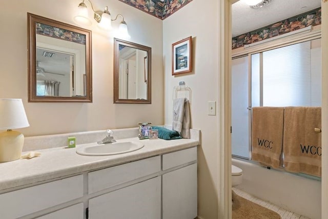 full bathroom featuring vanity, toilet, tile patterned flooring, and combined bath / shower with glass door