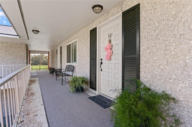 view of exterior entry with stucco siding