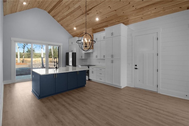 kitchen featuring light countertops, white cabinets, appliances with stainless steel finishes, wooden ceiling, and light wood-type flooring