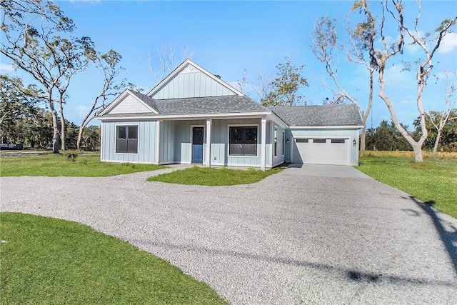 view of front of home featuring board and batten siding, an attached garage, a front lawn, roof with shingles, and driveway