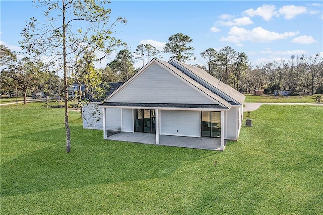 rear view of property featuring central air condition unit, a patio area, and a lawn