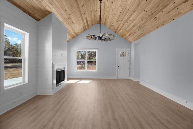 unfurnished living room featuring baseboards, light wood-type flooring, a fireplace, wooden ceiling, and high vaulted ceiling