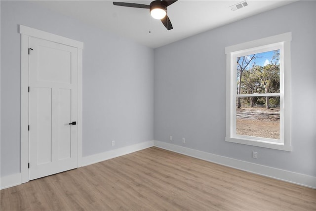 unfurnished bedroom featuring visible vents, baseboards, ceiling fan, and light wood finished floors