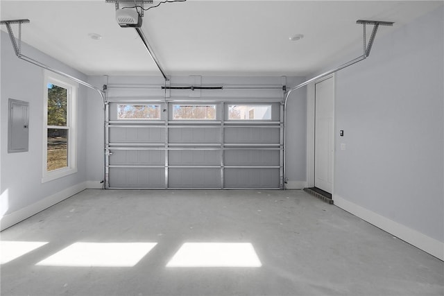 garage featuring electric panel, baseboards, and a garage door opener