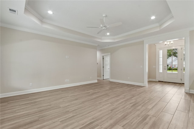 154 Ossabaw Way, Waverly, GA 31565 - empty room featuring a raised ceiling, a ceiling fan, crown molding, light wood-style flooring, and a chandelier