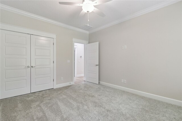 154 Ossabaw Way, Waverly, GA 31565 - unfurnished bedroom featuring carpet flooring, crown molding, a closet, and a ceiling fan