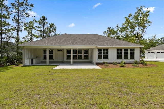 154 Ossabaw Way, Waverly, GA 31565 - back of house featuring a patio area, a shingled roof, and a lawn