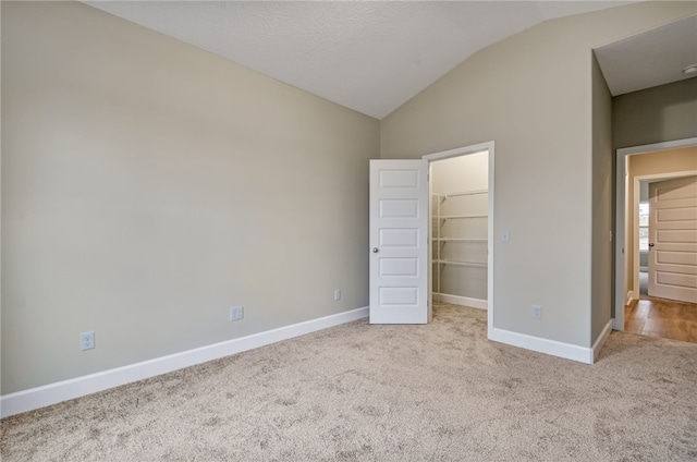 154 Ossabaw Way, Waverly, GA 31565 - unfurnished bedroom featuring lofted ceiling, carpet flooring, a spacious closet, baseboards, and a closet