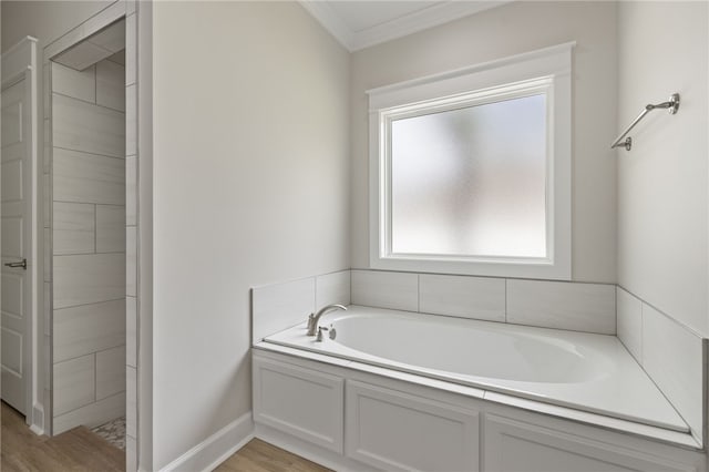 154 Ossabaw Way, Waverly, GA 31565 - bathroom featuring a bath, ornamental molding, and wood finished floors