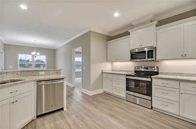 154 Ossabaw Way, Waverly, GA 31565 - kitchen featuring stainless steel appliances, a chandelier, light wood-style flooring, white cabinets, and ornamental molding