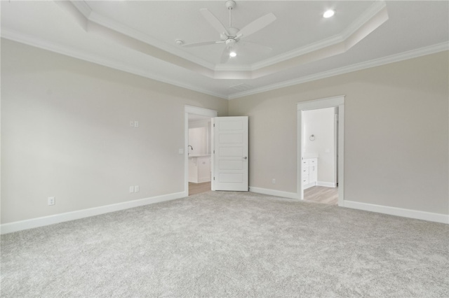 154 Ossabaw Way, Waverly, GA 31565 - unfurnished bedroom with a tray ceiling, light colored carpet, crown molding, ensuite bathroom, and recessed lighting