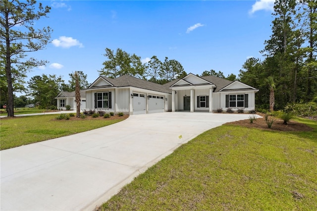 154 Ossabaw Way, Waverly, GA 31565 - view of front of house featuring a garage, driveway, and a front lawn