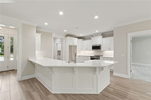 154 Ossabaw Way, Waverly, GA 31565 - kitchen featuring stainless steel appliances, crown molding, a peninsula, light countertops, and white cabinets