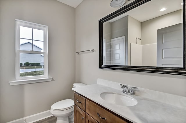 154 Ossabaw Way, Waverly, GA 31565 - bathroom with toilet, vanity, baseboards, and wood finished floors