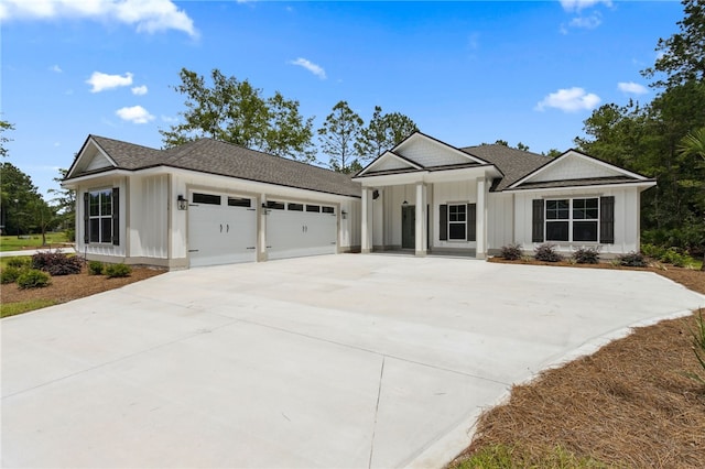 154 Ossabaw Way, Waverly, GA 31565 - view of front of home with board and batten siding, concrete driveway, and a garage