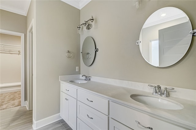 154 Ossabaw Way, Waverly, GA 31565 - full bathroom featuring ornamental molding, double vanity, a walk in closet, baseboards, and wood finished floors
