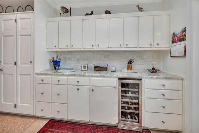 1212 River Club Dr, Sea Island, GA 31561 - kitchen featuring beverage cooler, white cabinets, and decorative backsplash