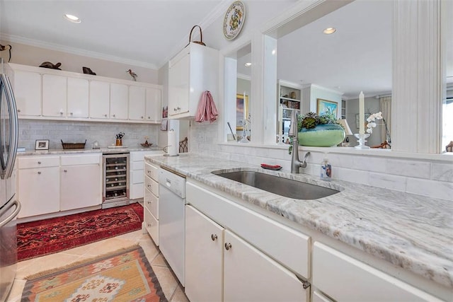 1212 River Club Dr, Sea Island, GA 31561 - kitchen featuring ornamental molding, wine cooler, tasteful backsplash, white cabinets, and dishwasher